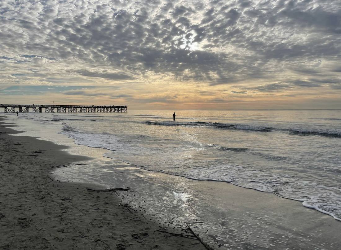 Beach and fishing pier at sunrise