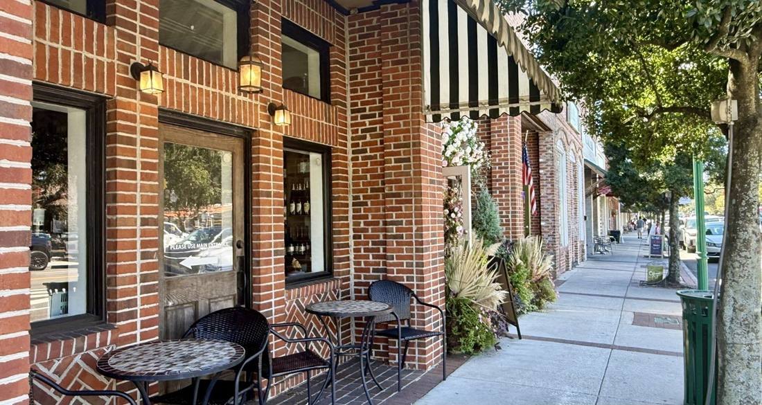 Brick storefronts and café tables in downtown Summerville