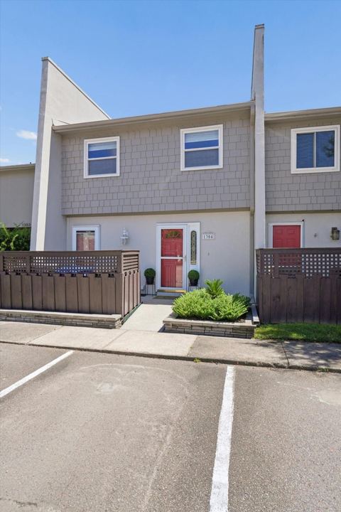 Front of the townhome with its private fenced patio