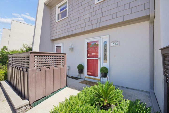 Front entry with red door and patio