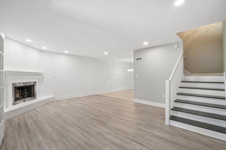 Living room with fireplace and stairs