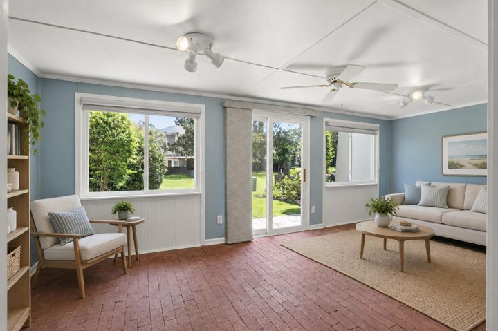 Enclosed sunroom with brick floor and doors to the yard